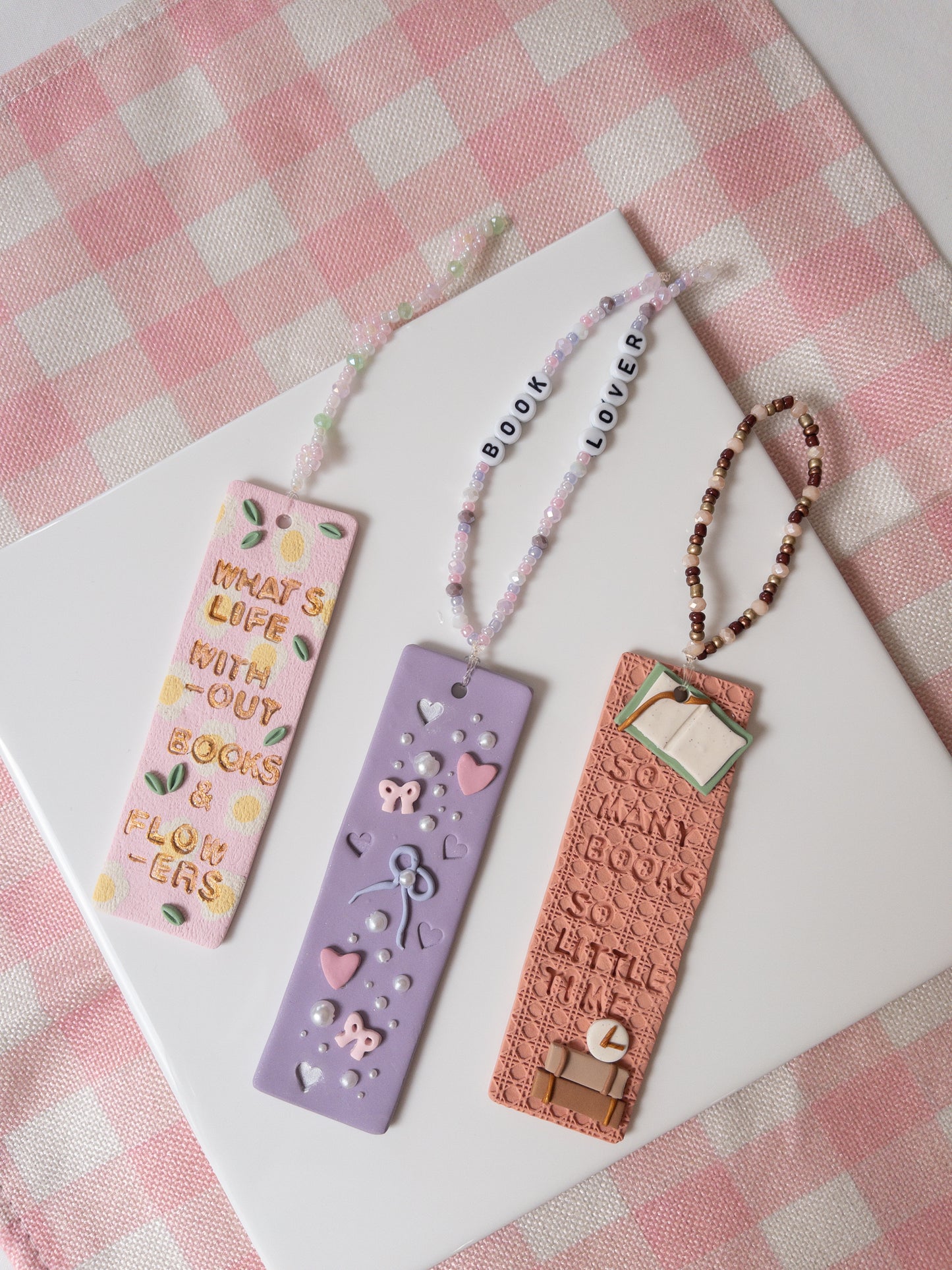 Promotional image for Two Clay Hearts Polymer Clay Workshops, showcasing various craft projects made from polymer clay and indicating the types of workshops offered, such as bookmarks.