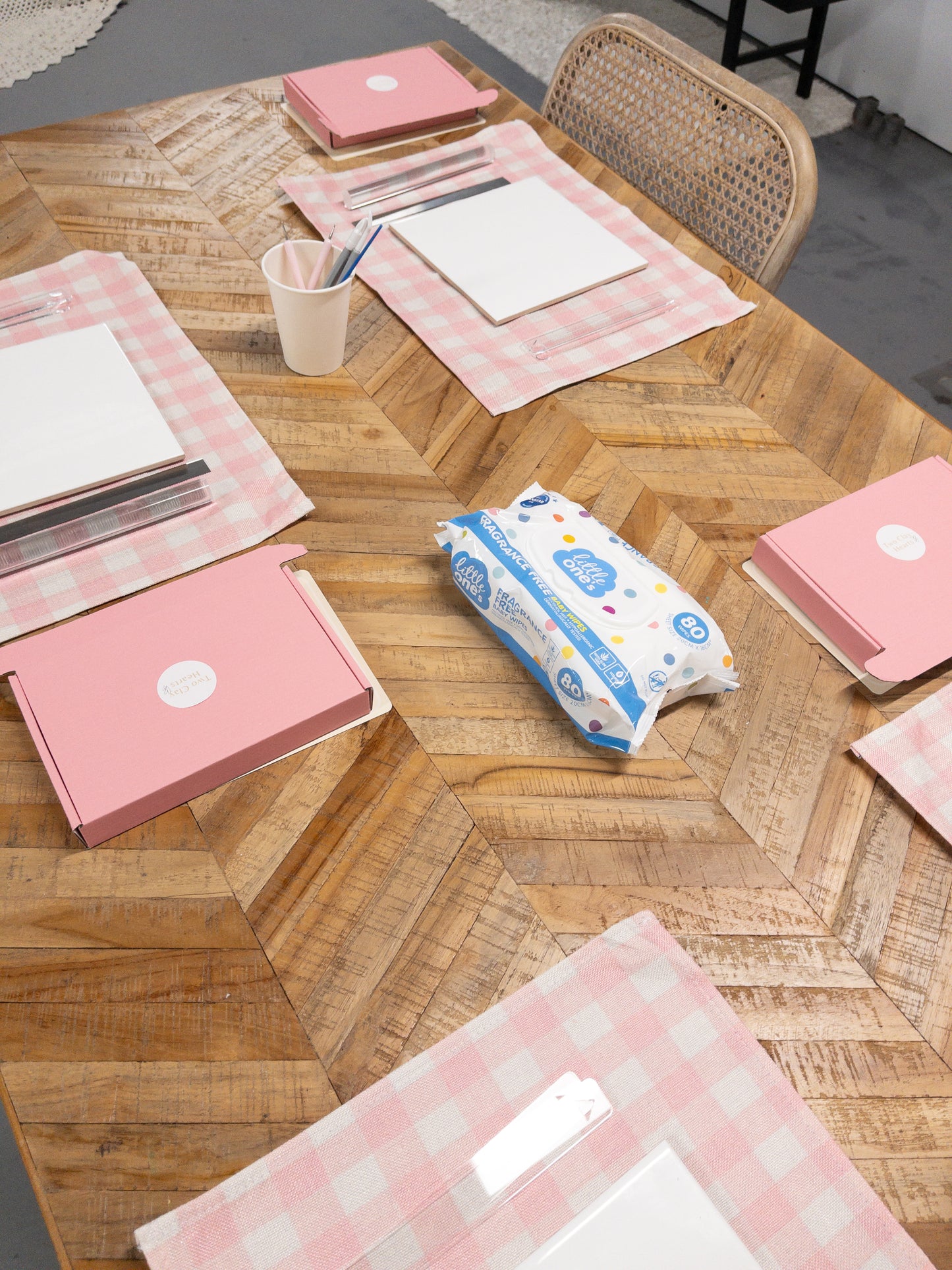 Pink craft items on a wooden table .