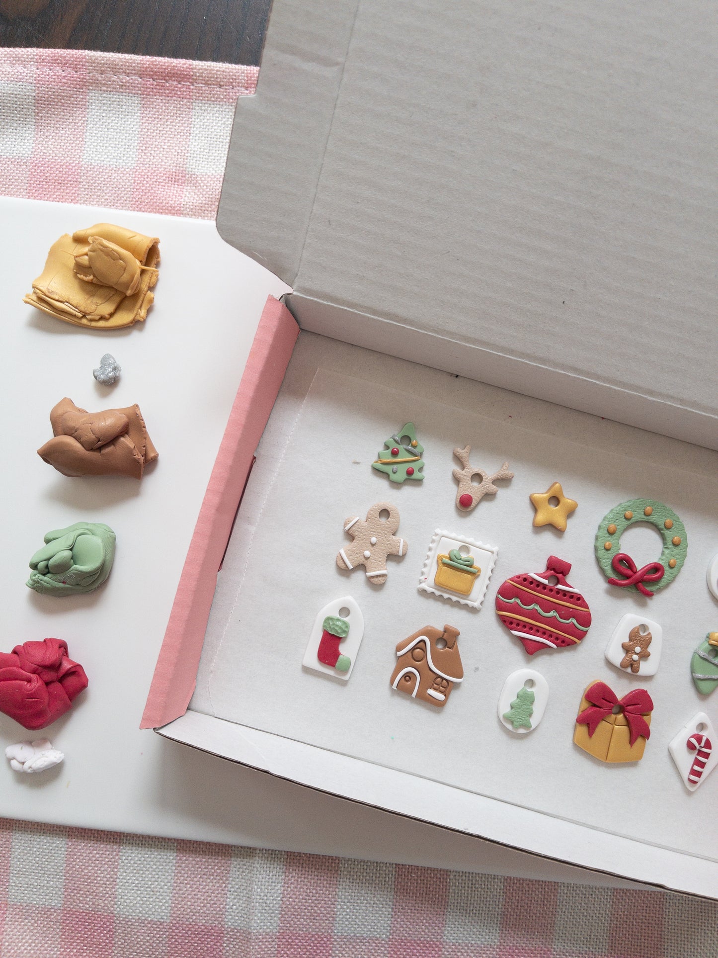 Assorted colorful clay Christmas hoop charms on a checkered tablecloth