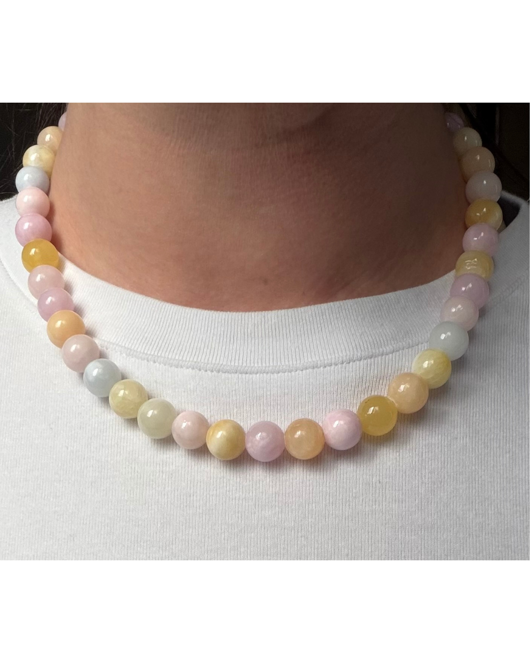 Chunky pastel coloured beaded necklace on model wearing white t-shirt