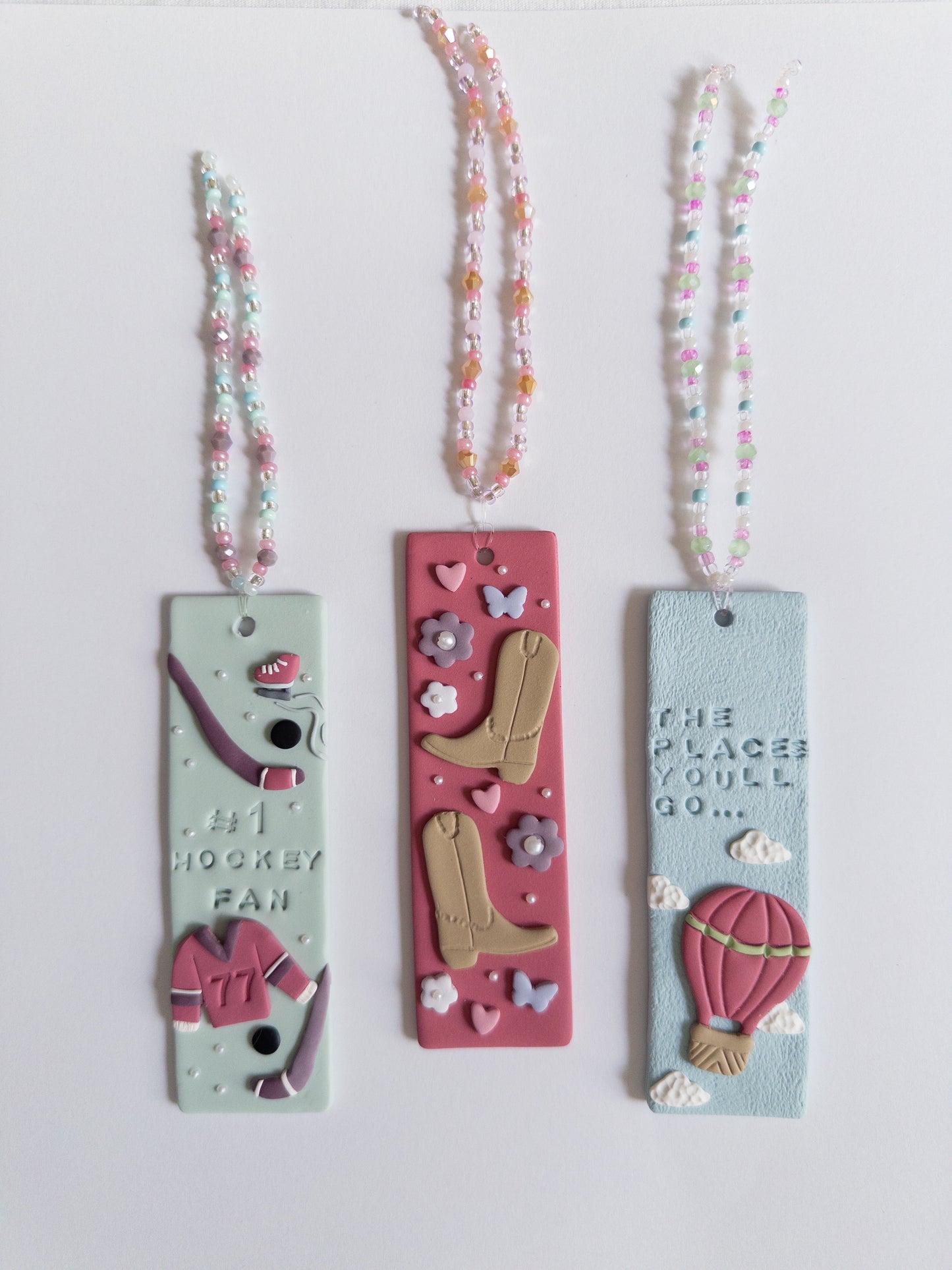 Multiple designed polymer clay bookmarks on white background