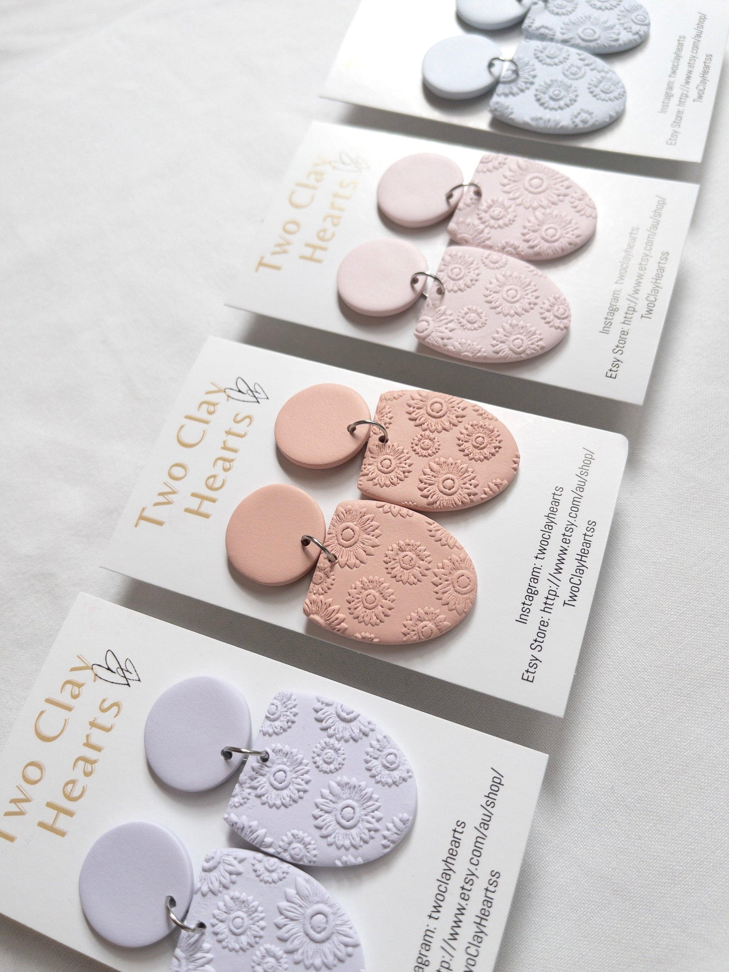 Pastel half oval dangle earrings with a flower print