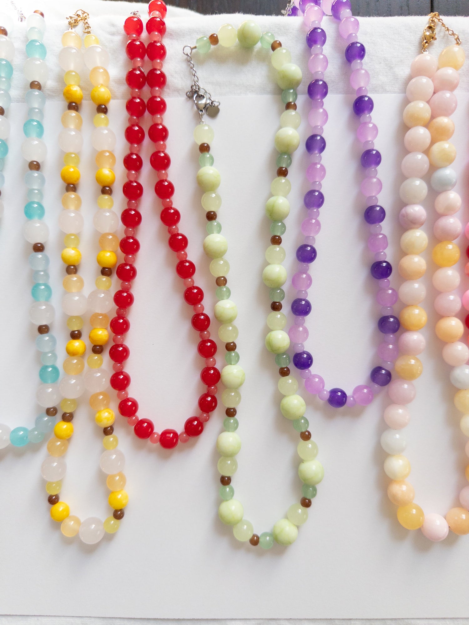 Glass beaded necklaces on white background