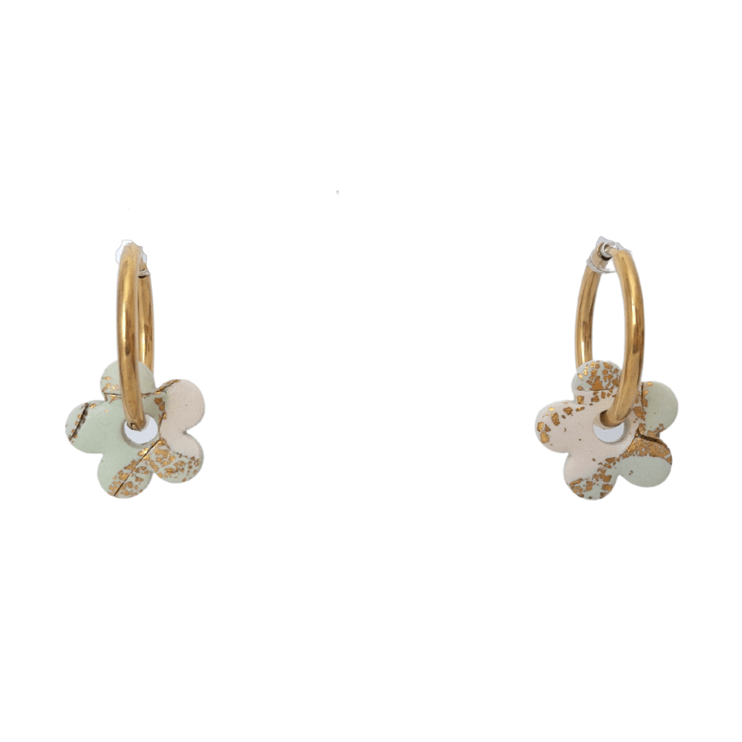 Pastel green, white and gold flower pieces on a gold hoop earring.