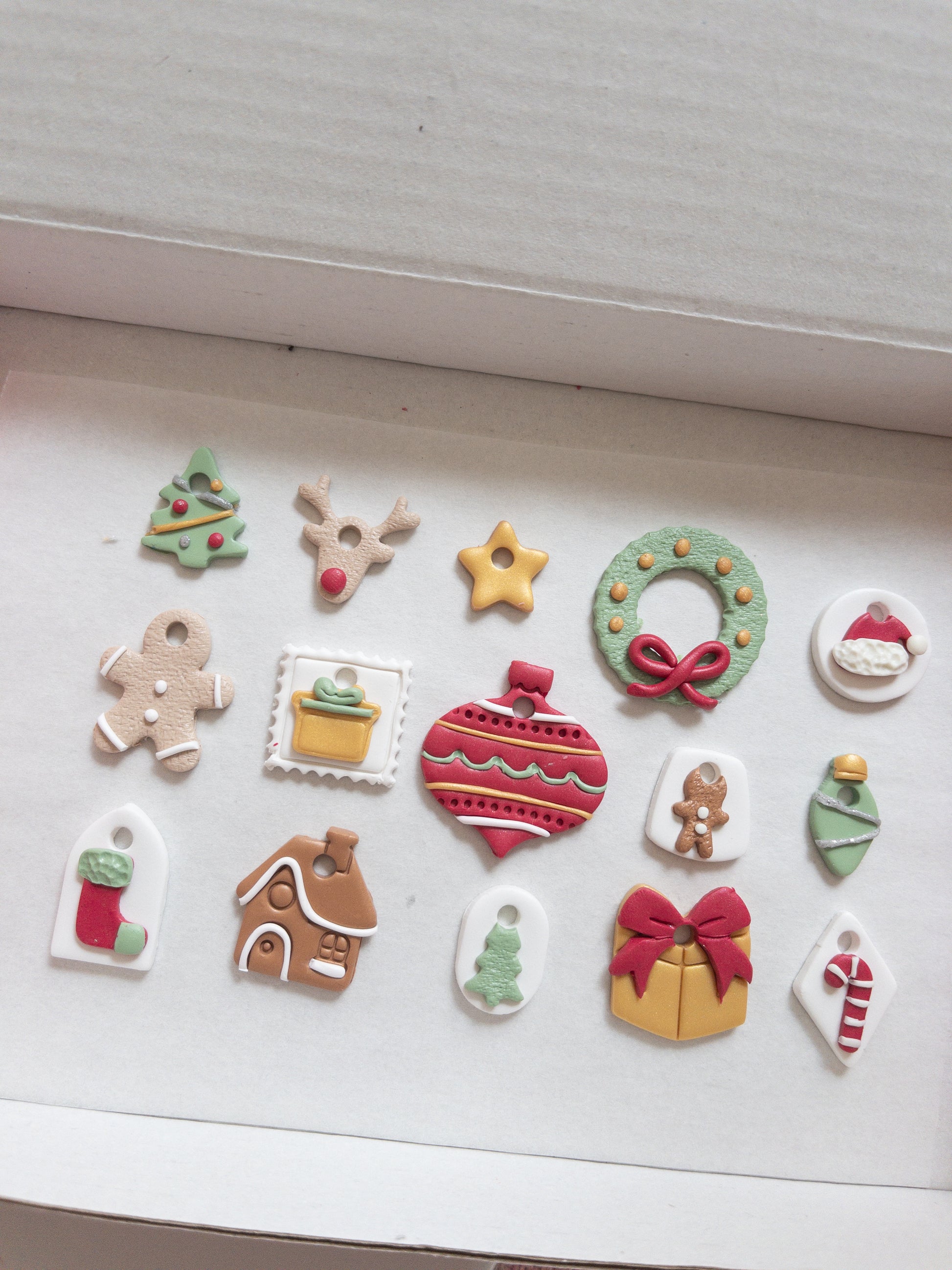 Collection of Christmas-themed hoop charms on a white surface