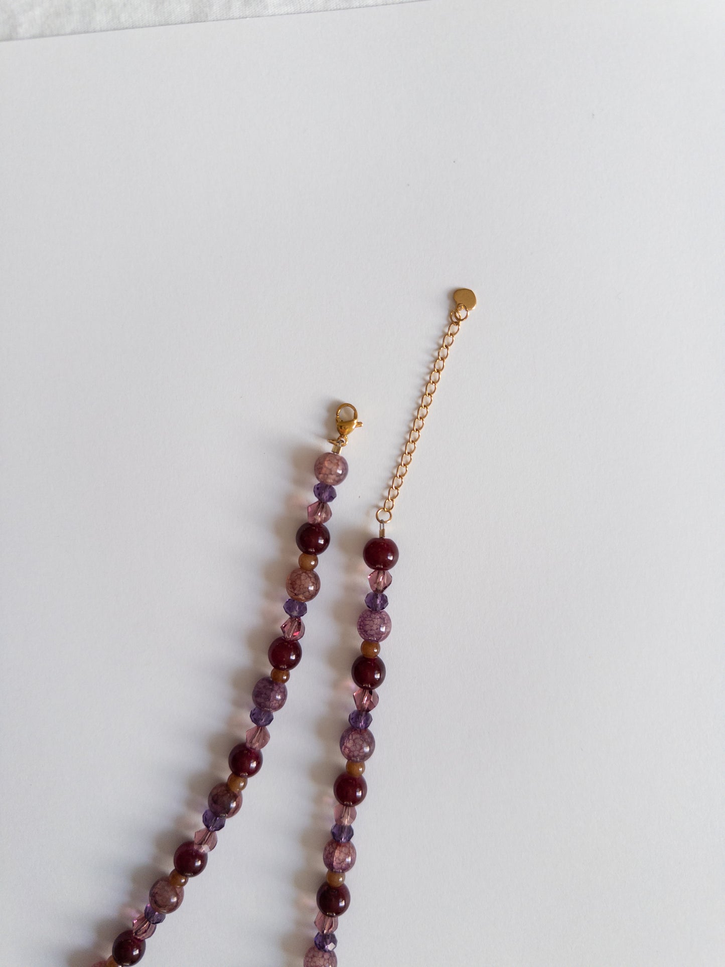 Close up on beaded necklace, gold plated clasp extender
