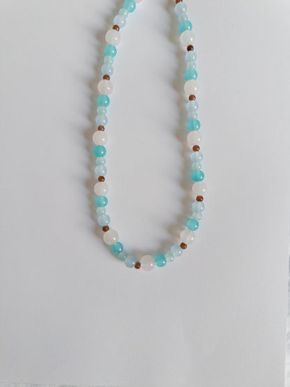 Blue and brown beaded necklace on white background