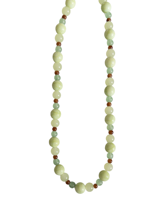 Green and brown beaded necklace on a white background