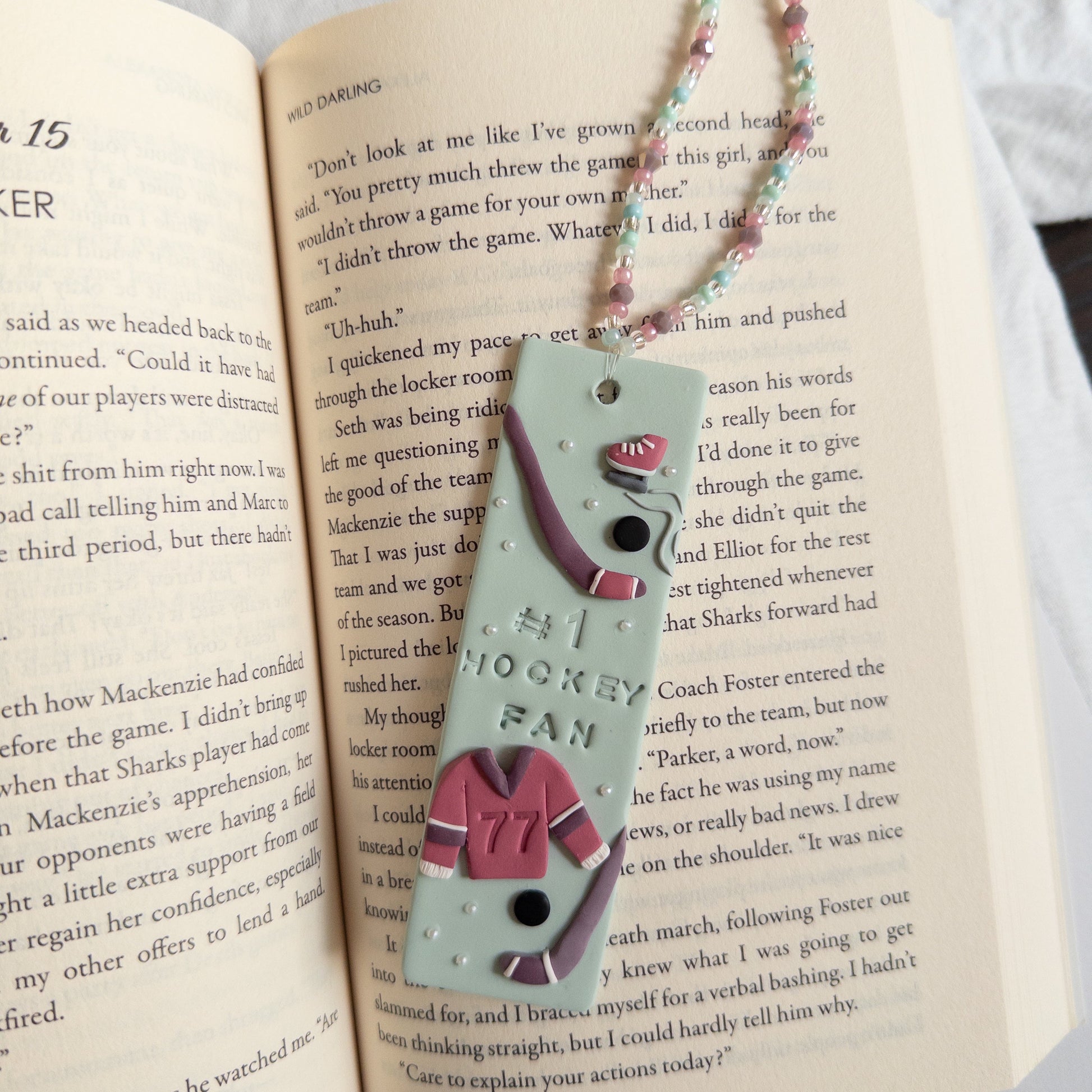 Polymer clay bookmark and beaded tassel on open page of book