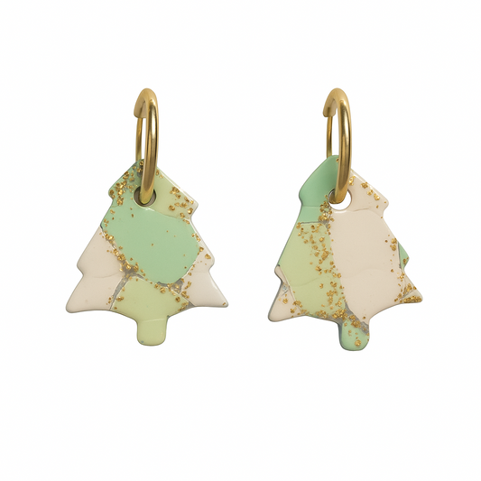 Pair of earrings shaped like Christmas trees with green and gold accents on a white background