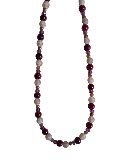 dark purple and magenta beaded necklace on white background