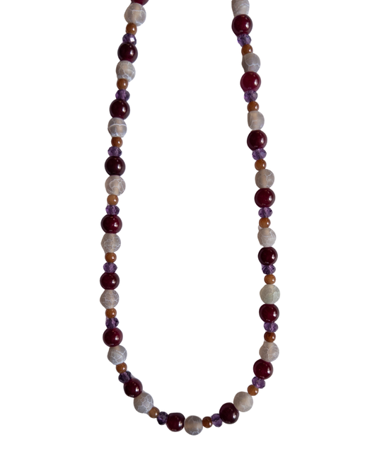 dark purple and magenta beaded necklace on white background