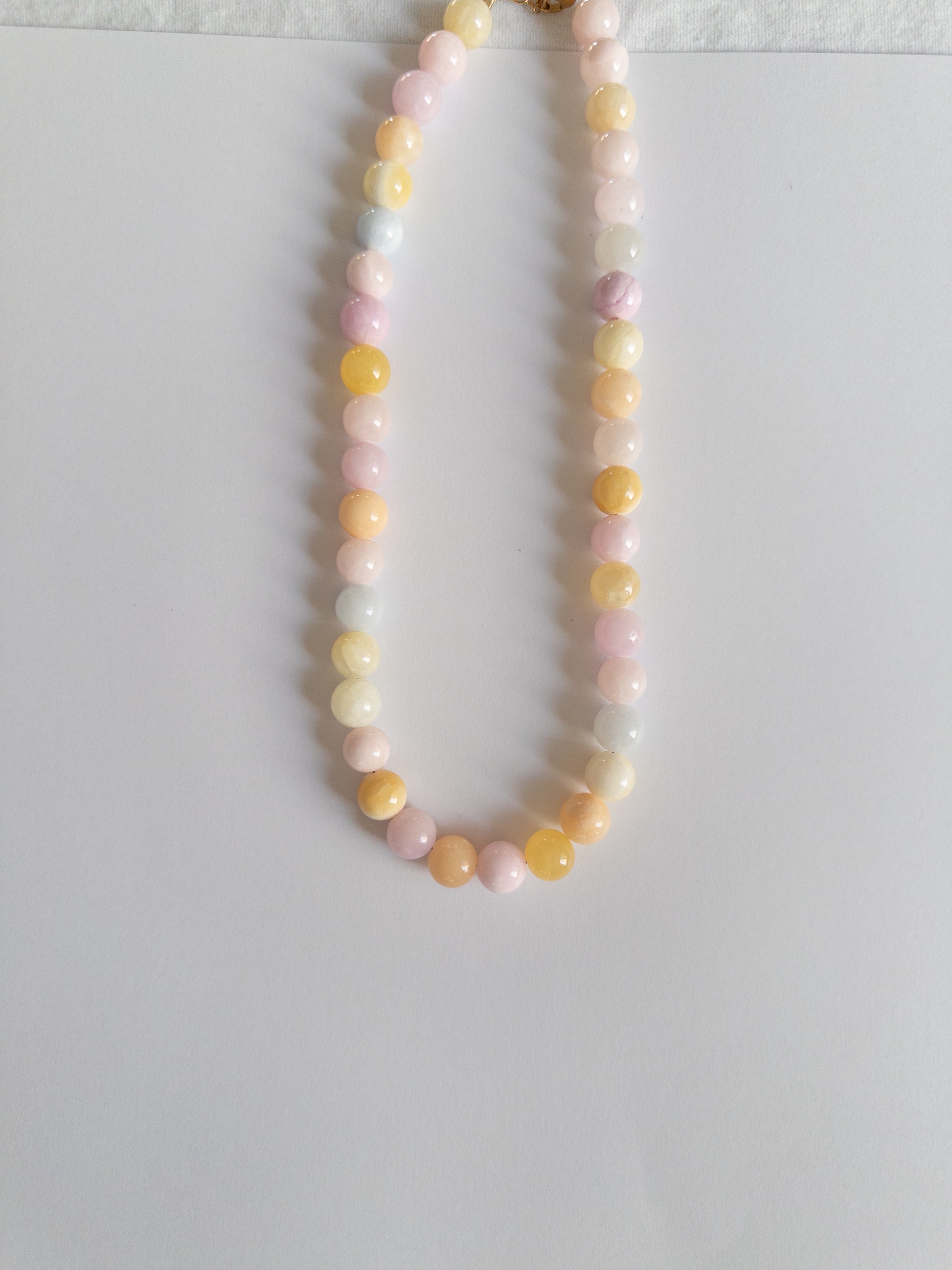 Chunky pastel coloured beaded necklace on a white background