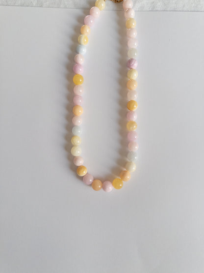 Chunky pastel coloured beaded necklace on a white background