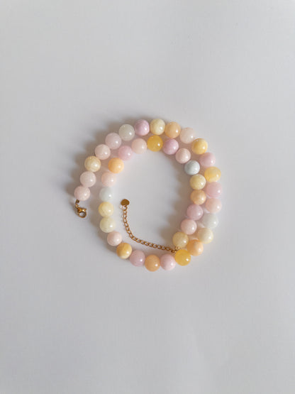 Chunky pastel coloured beaded necklace styled on a white background