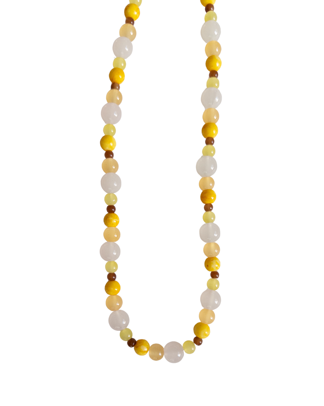 Yellow, brown and clear beaded necklace on white background