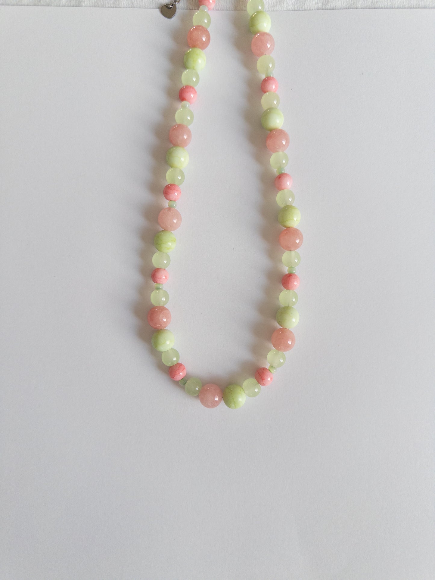 Pink and Green glass bead necklace on white background
