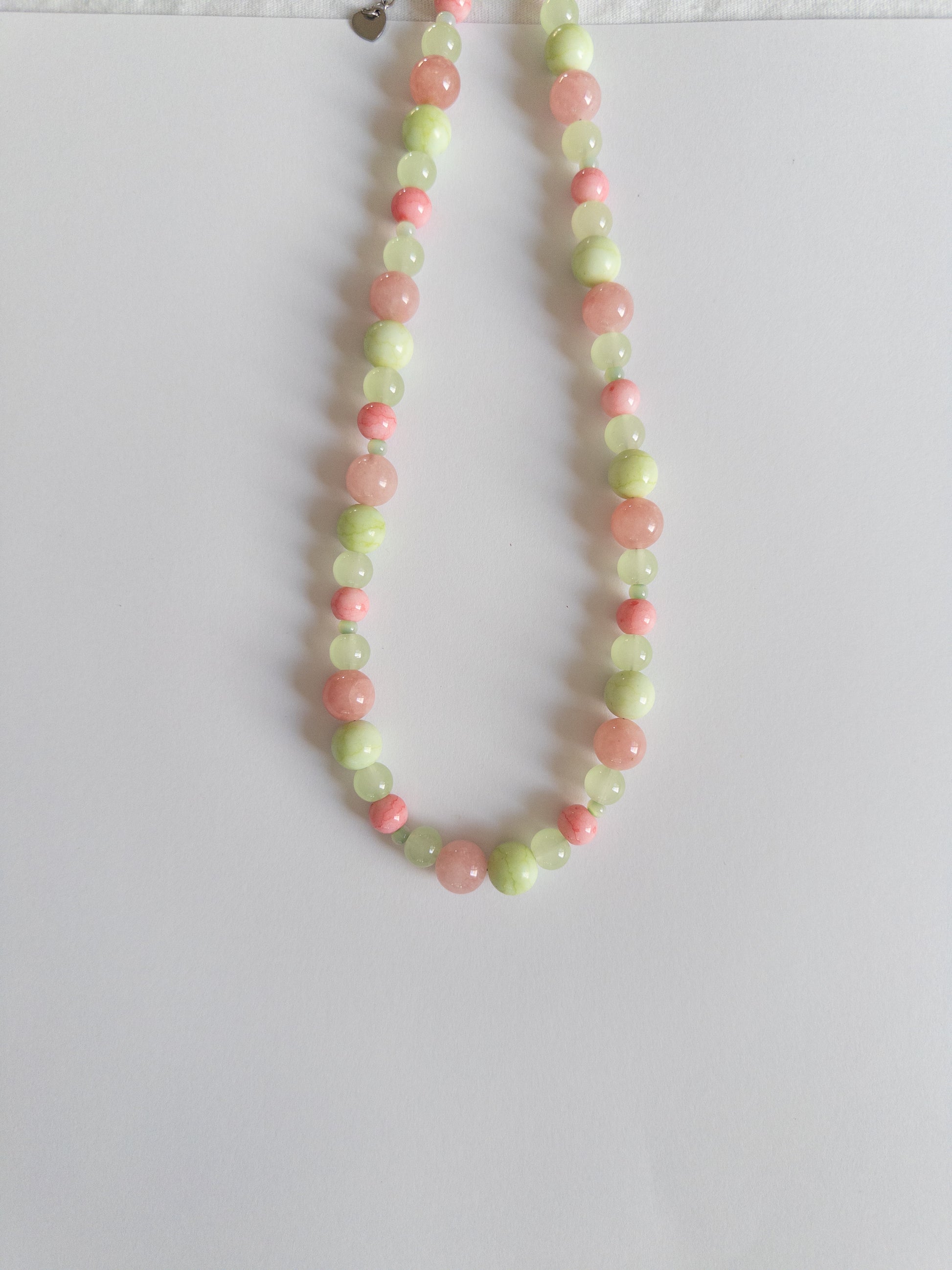 Pink and Green glass bead necklace on white background
