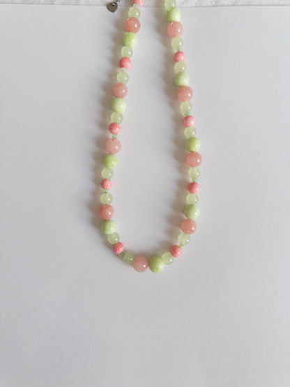 Pink and Green glass bead necklace on white background
