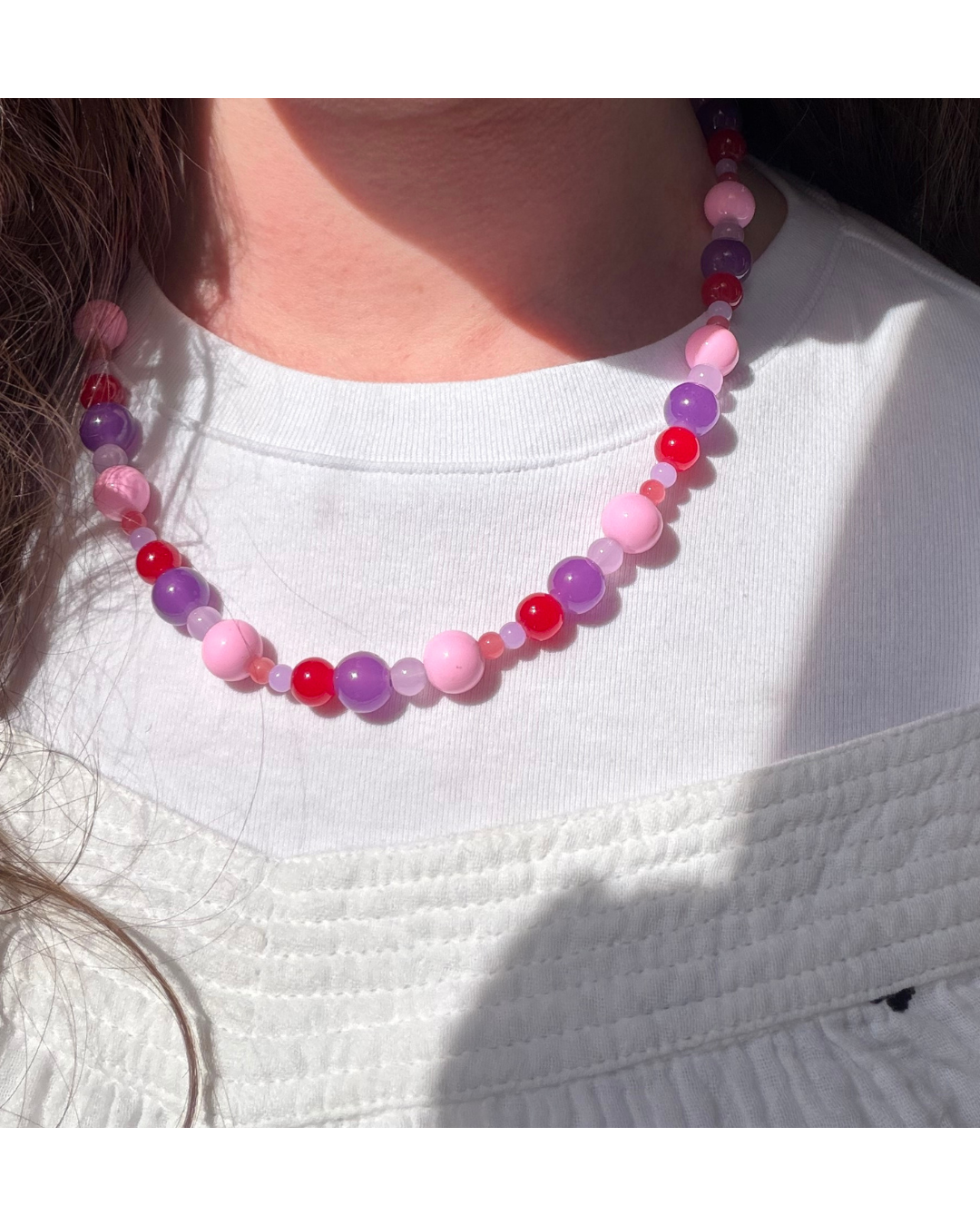 Chunky beaded necklace on model wearing a white t-shirt