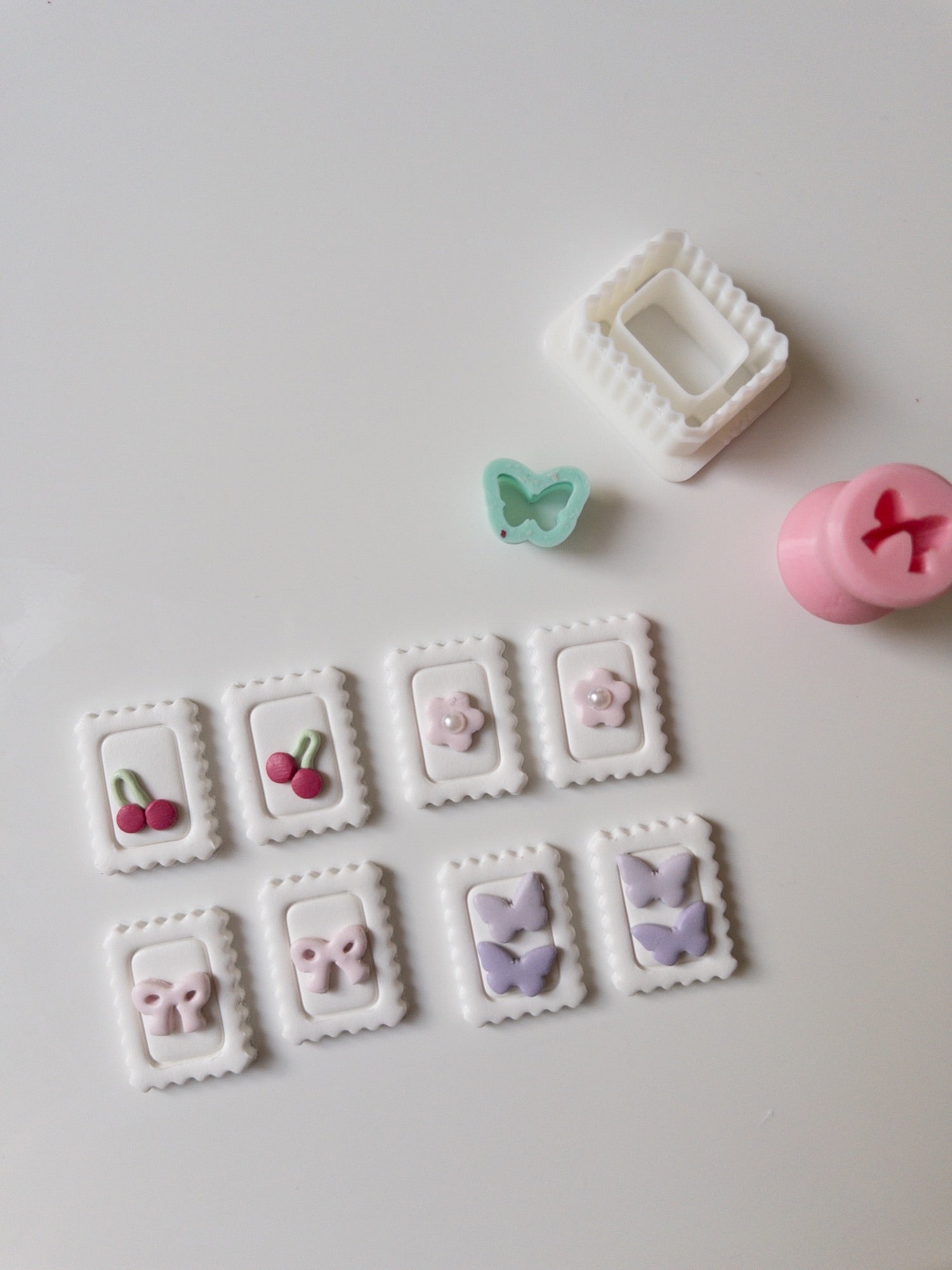 Decorative clay pieces with cutters on a white surface
