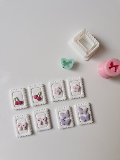 Decorative clay pieces with cutters on a white surface