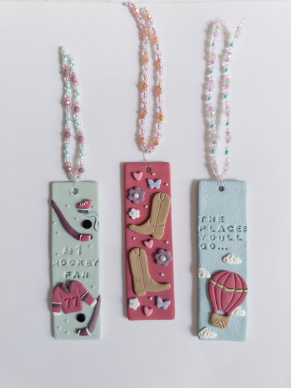 Multiple designed polymer clay bookmarks on white background