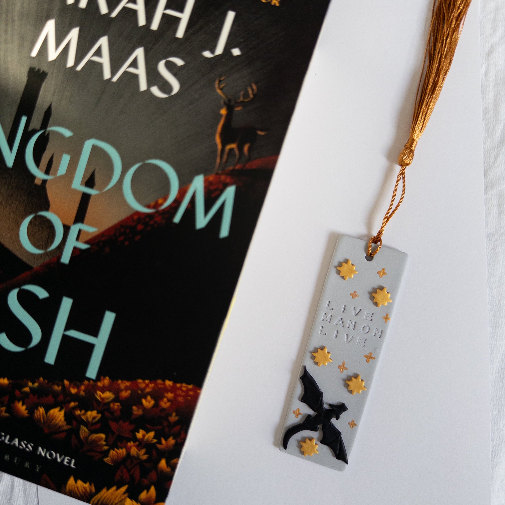 Dragon design bookmark next to fantasy book.