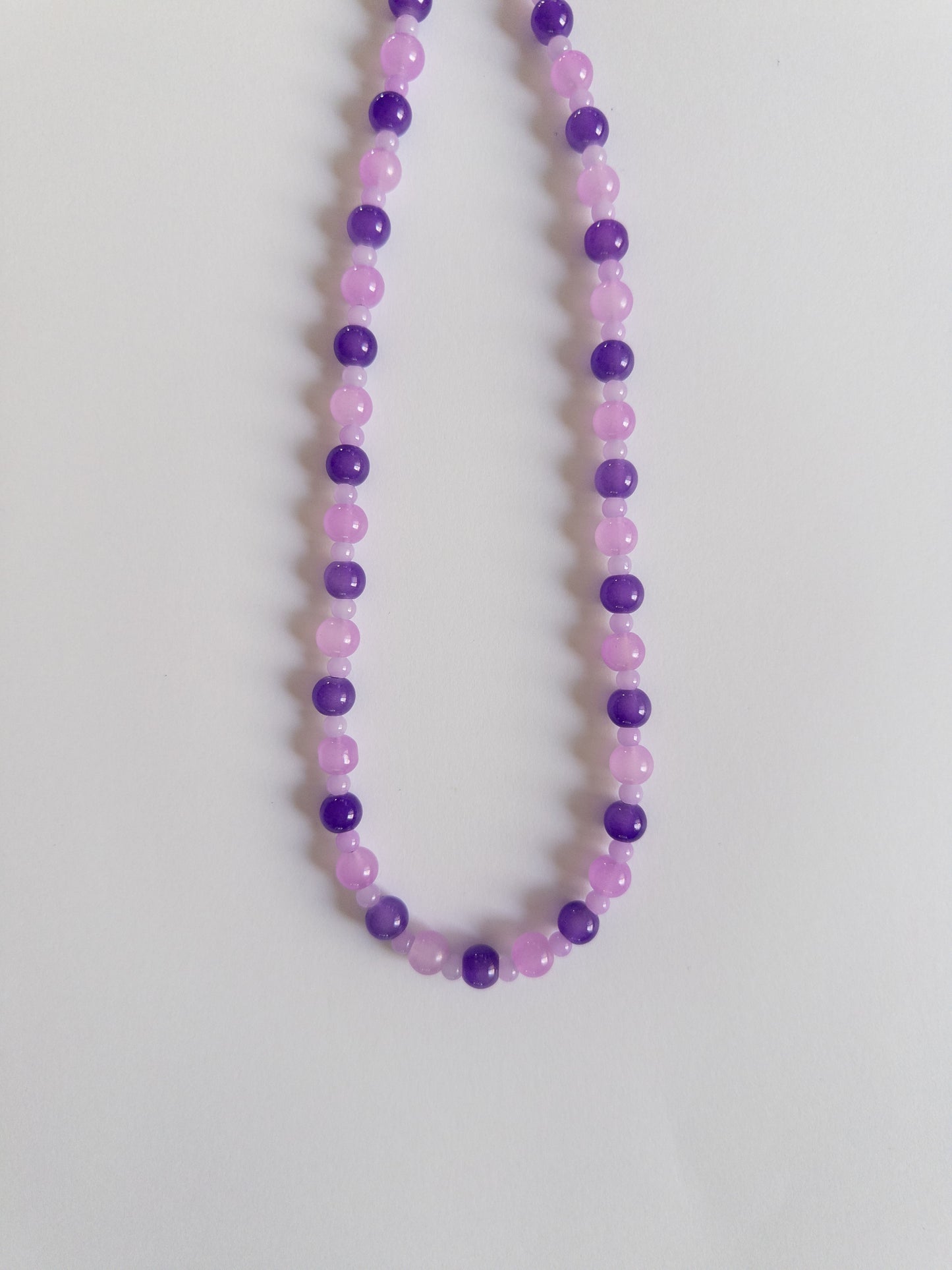 Dark and Light purple beaded necklace on white background