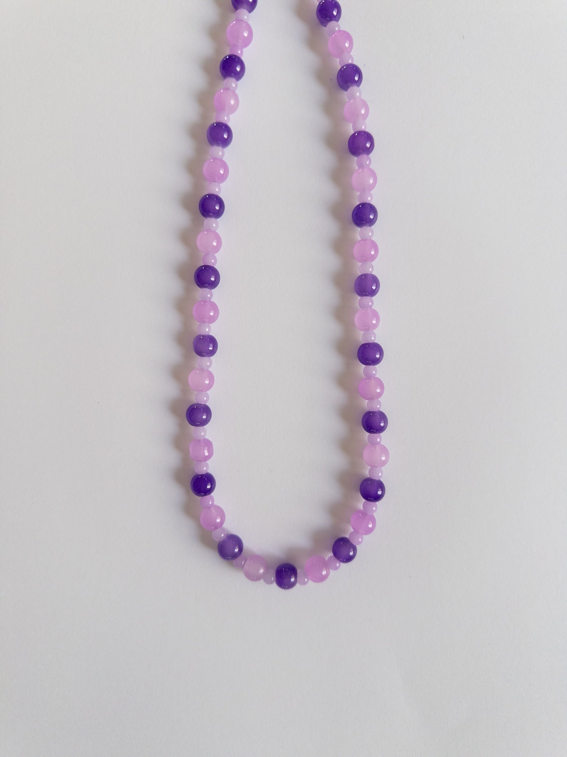 Dark and Light purple beaded necklace on white background