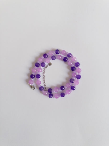 Dark and Light purple beaded necklace styled on white background