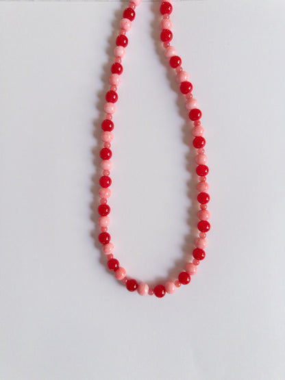 Red and Pink Beaded Necklace on a plain white background
