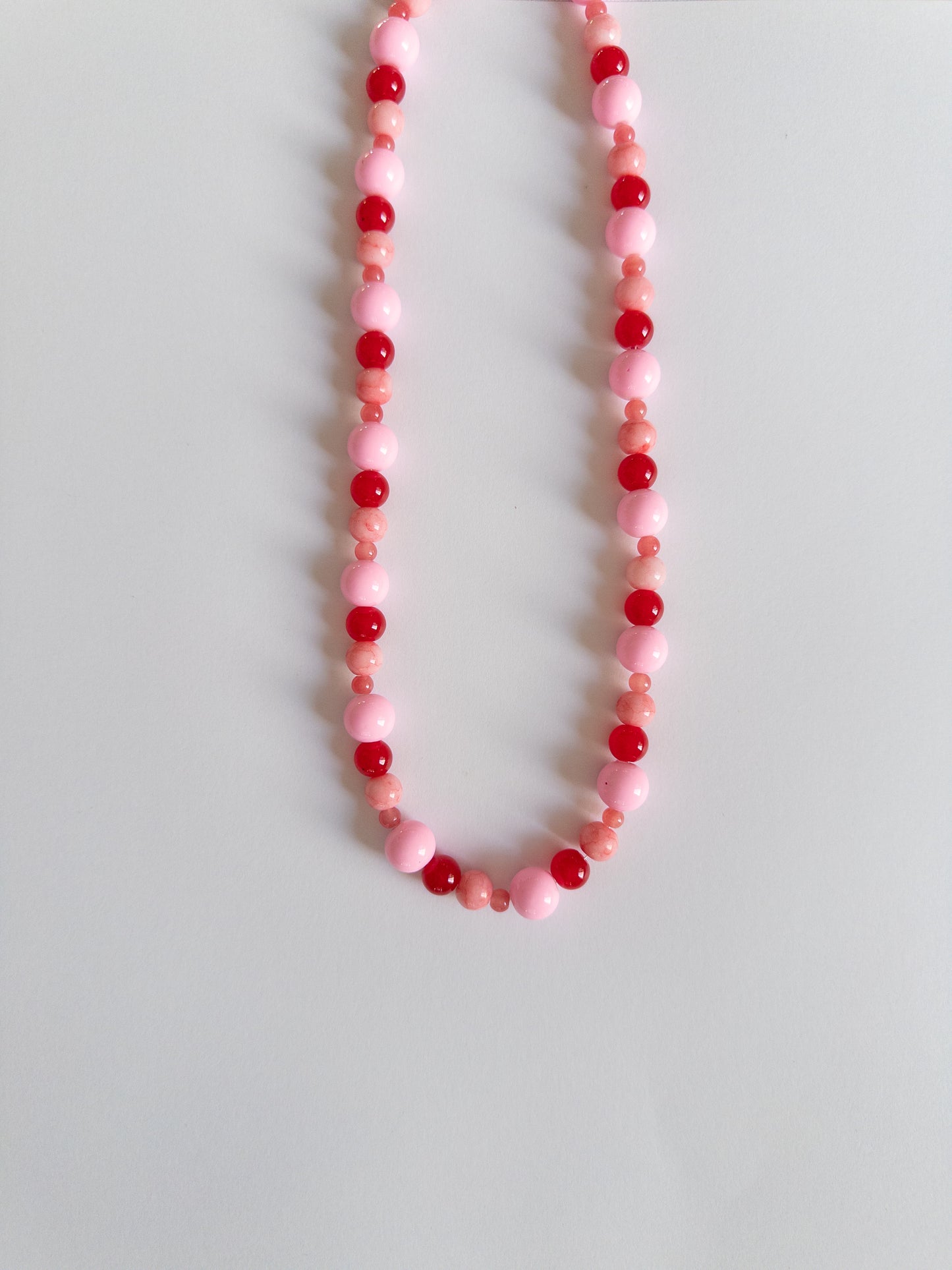 Red and Pink chunky beaded necklace on a white background