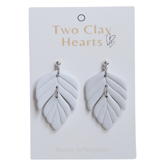 Blue polymer clay statement earring on white backing card