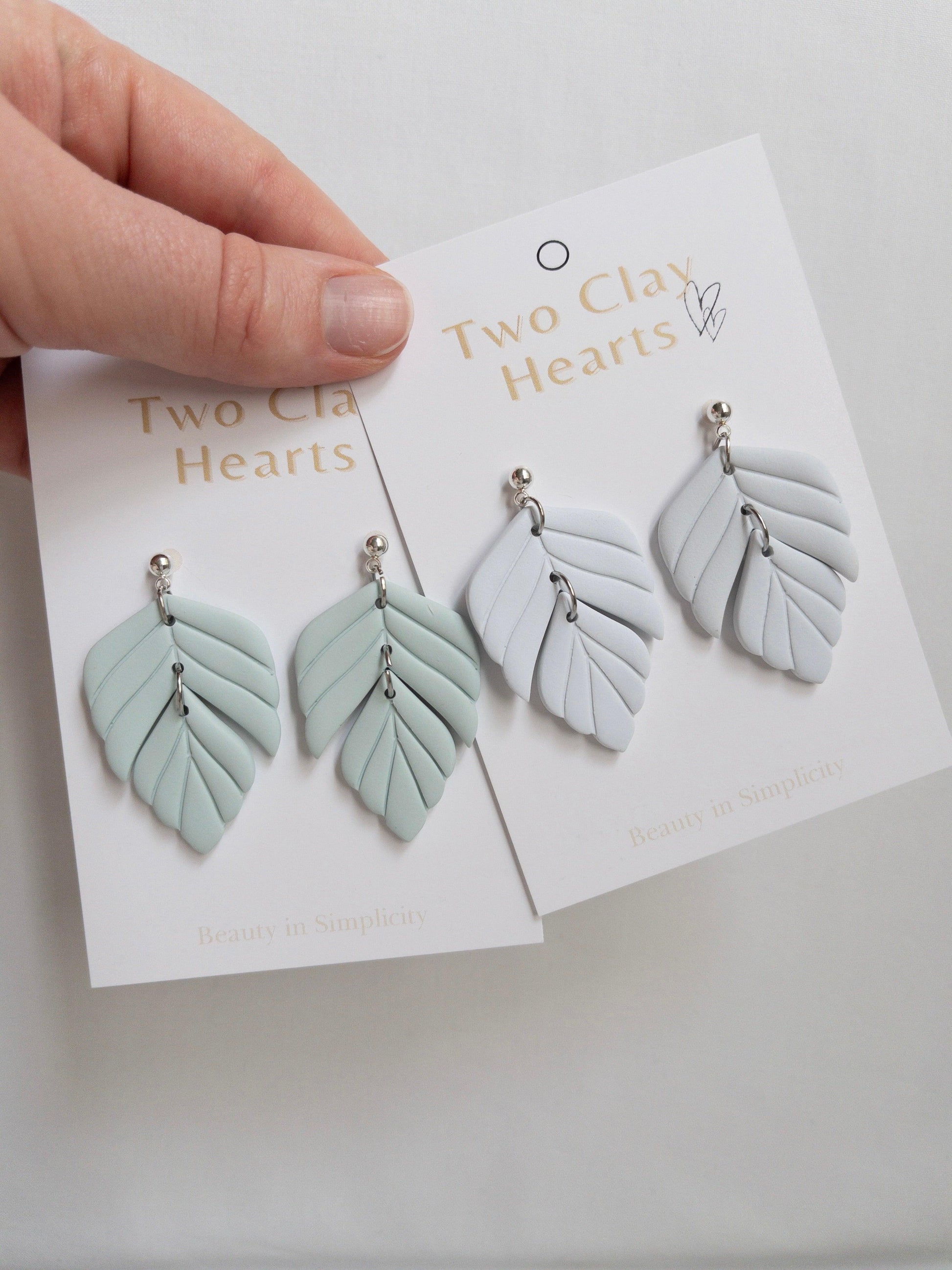 Polymer clay statement earrings on white backing cards