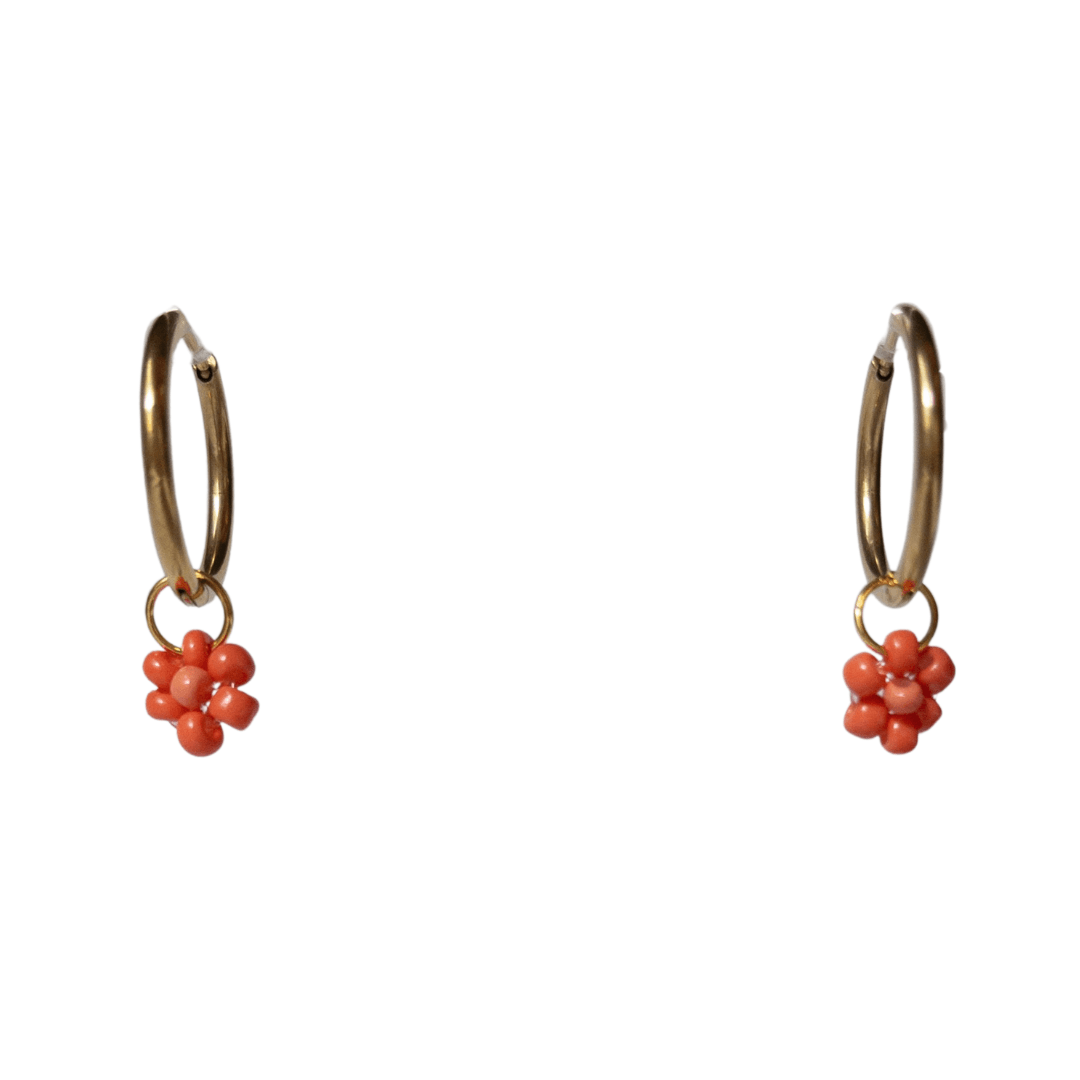 Close up on gold hoops with coral beaded flowers