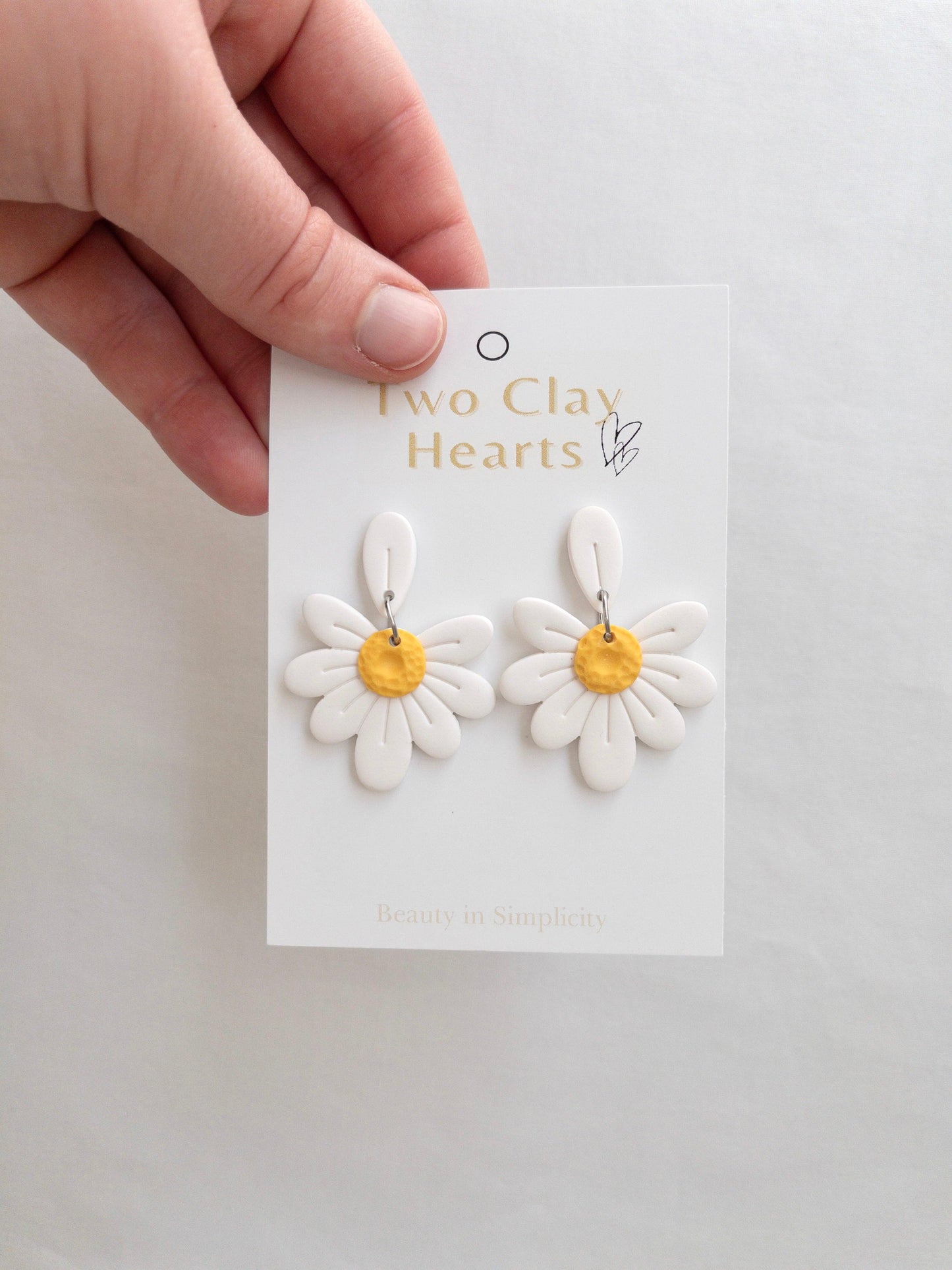 white daisy dangle earrings with a yellow centre