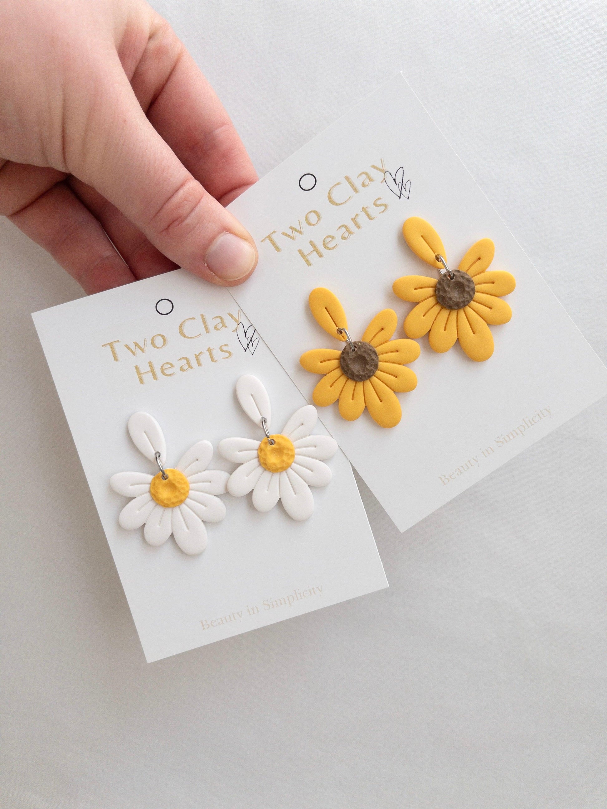 white daisy and yellow sunflower dangle earrings with petal details