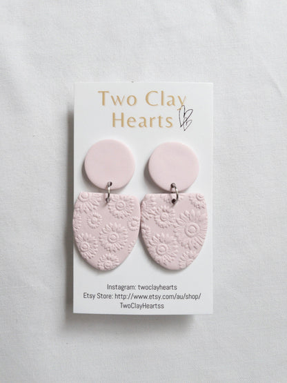 pastel pink half oval earrings with a flower texture