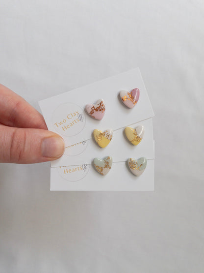 Pastel and gold heart shaped stud earrings on white backing card