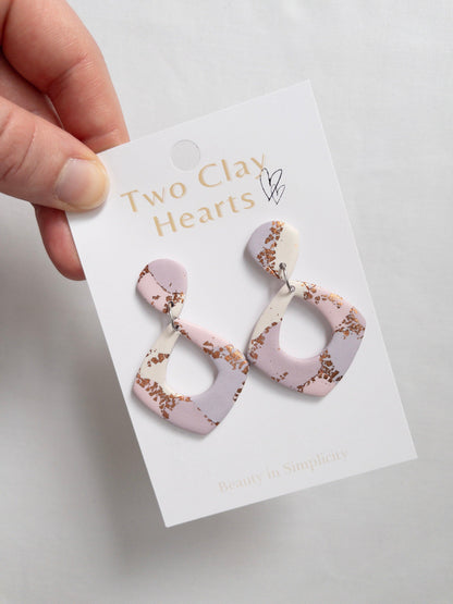 Pink, purple and rose gold patterned dangle earrings in a diamond shape