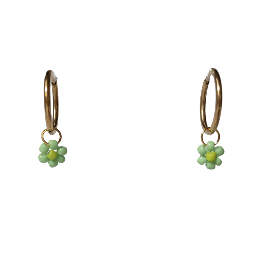 Close up on gold hoops with green beaded flowers