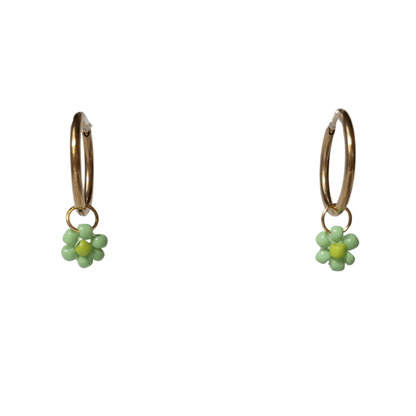 Close up on gold hoops with green beaded flowers