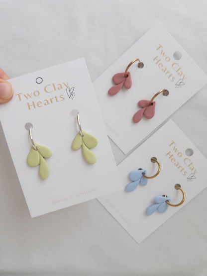 Leaf shaped pendants on hoop earrings