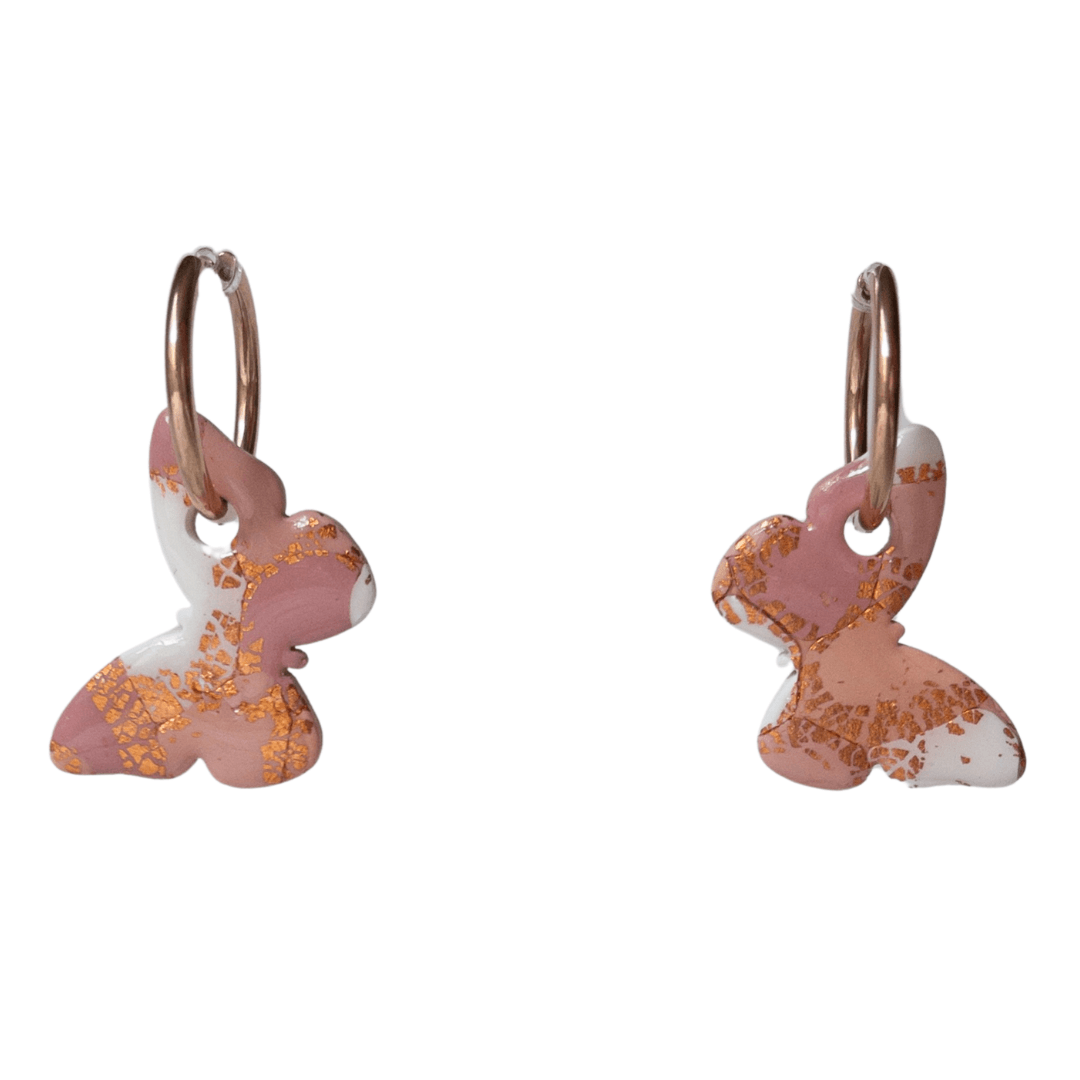 Close up of maroon, orange, white and rose gold large butterfly hoops