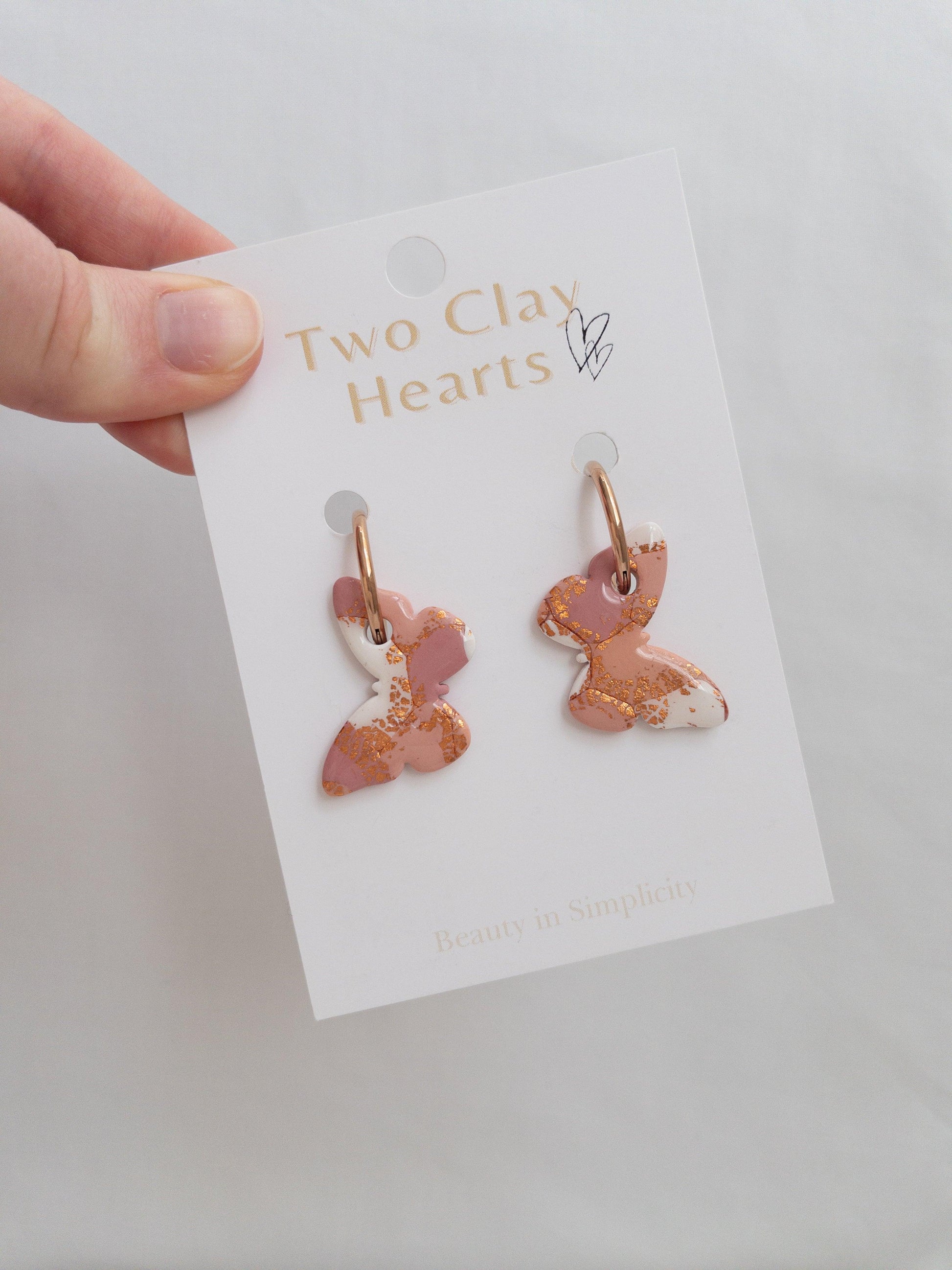 Large orange, maroon and rose gold butterfly  hoops on backing card