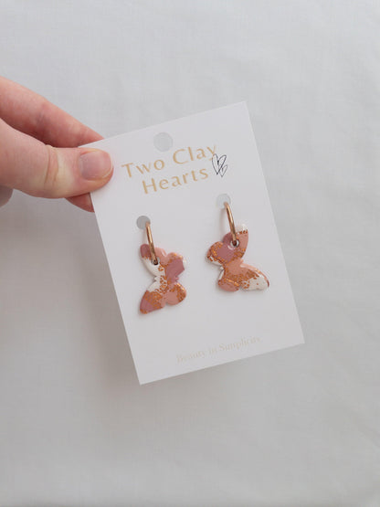 Large orange, maroon and rose gold butterfly  hoops on backing card