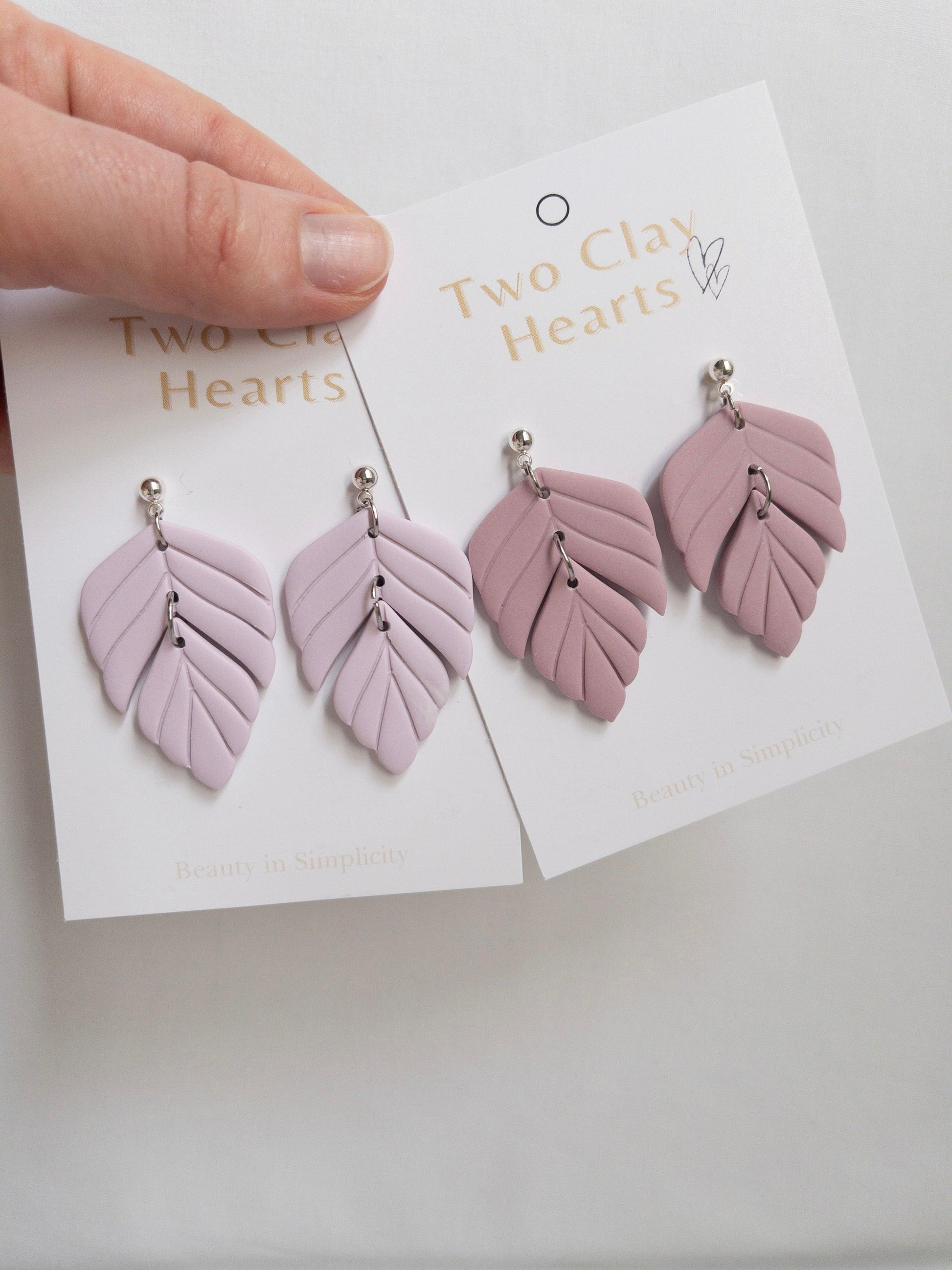 Polymer clay statement earrings on white backing cards