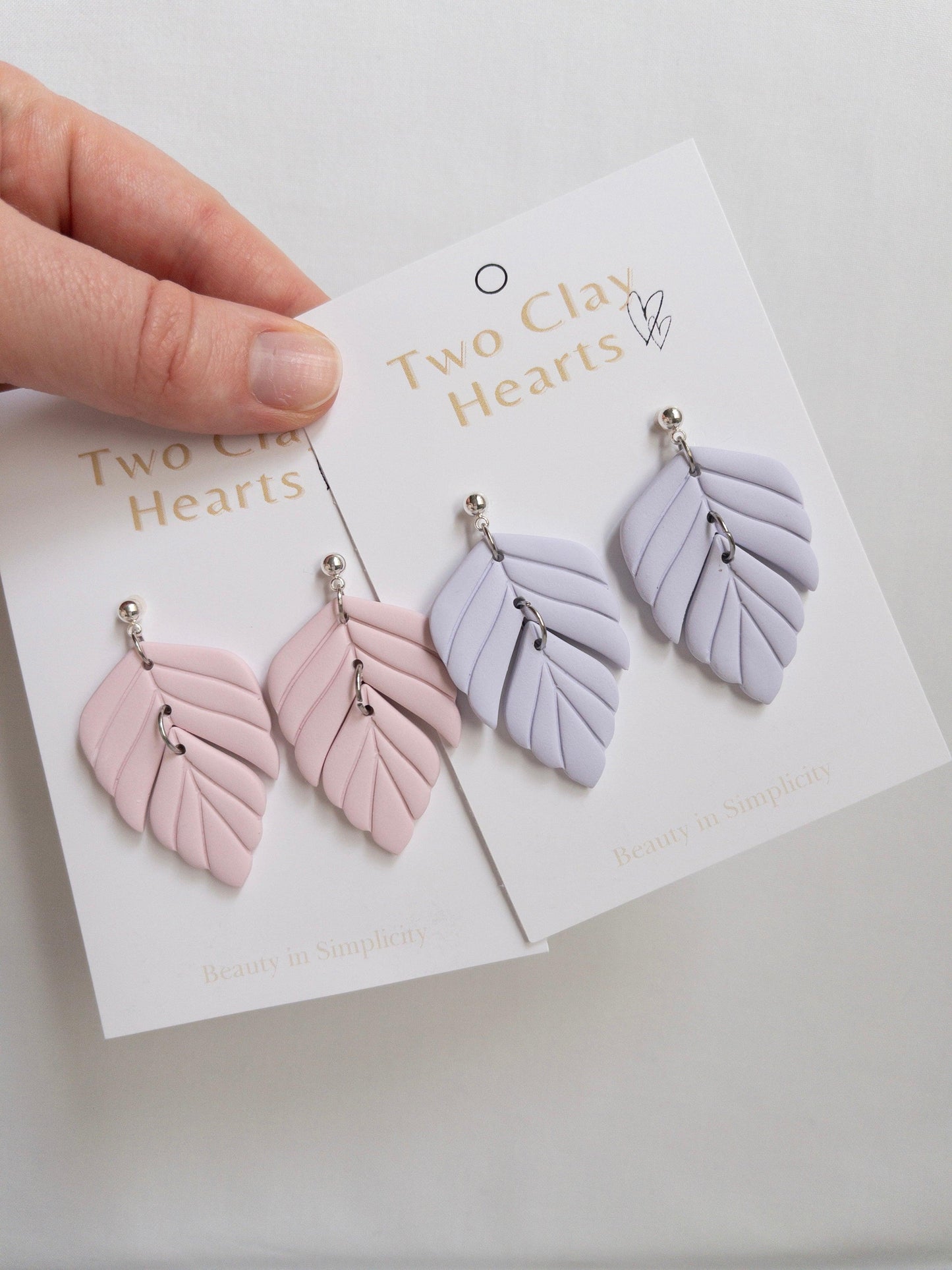 Polymer clay statement earrings on white backing cards