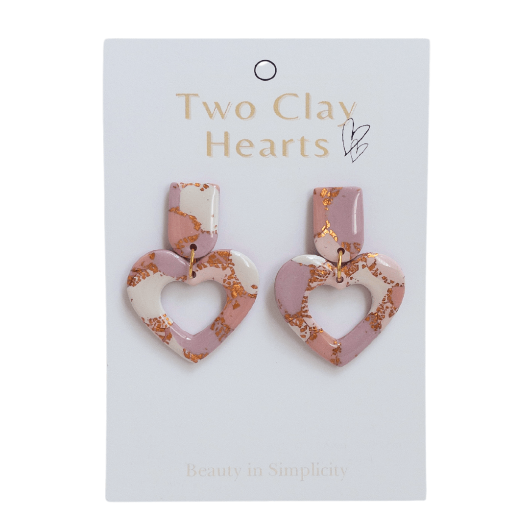 Pink and rose gold heart dangle earrings on white backing card